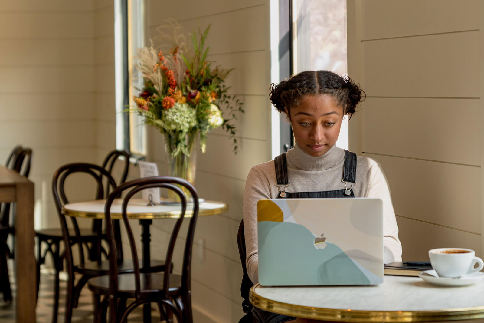 Local Resources Girl on computer at table in Bob's Well Bread