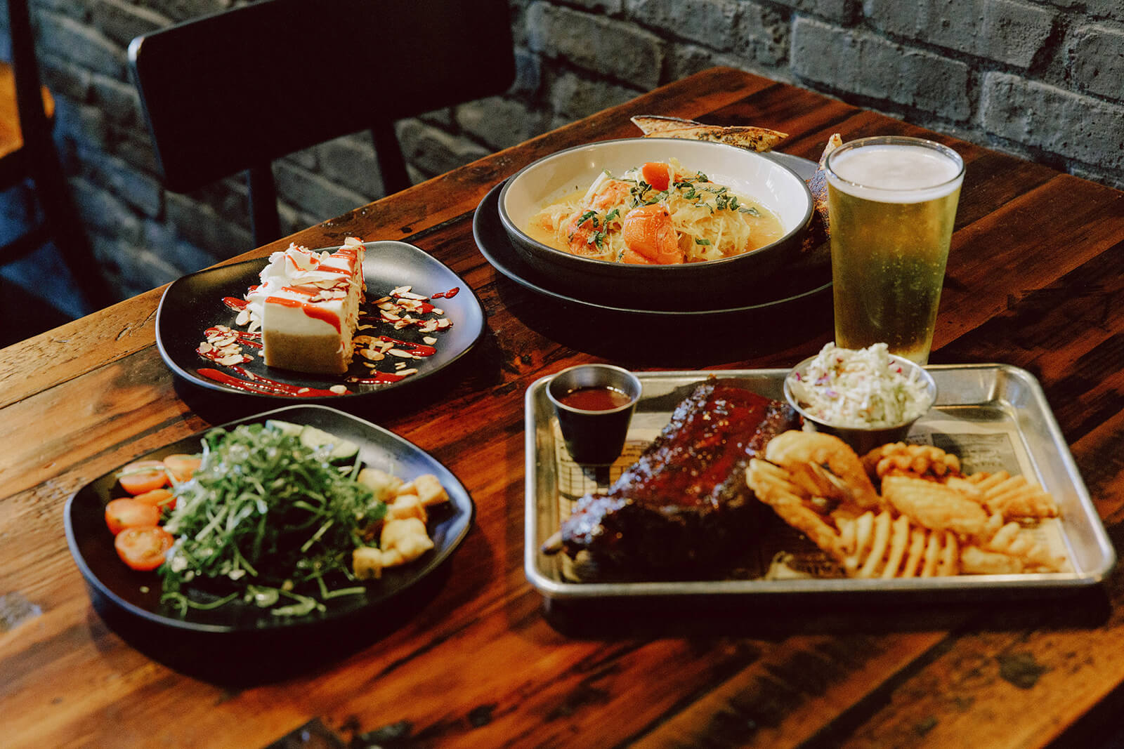 Restaurant Week Table with plates of food and a glass of beer