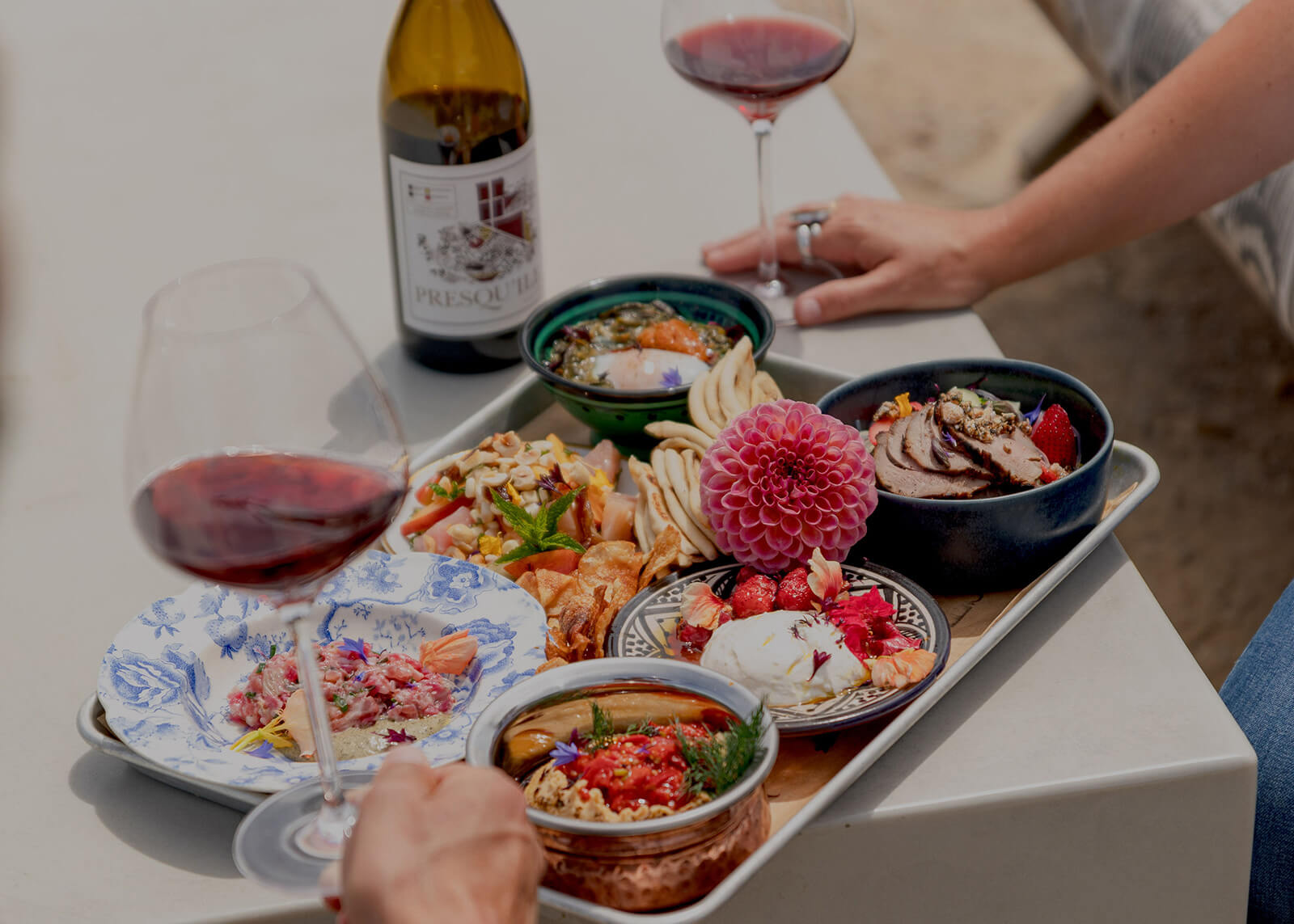 Wine and tapas snacks in small bowls on an outdoor table in the Santa Ynez Valley