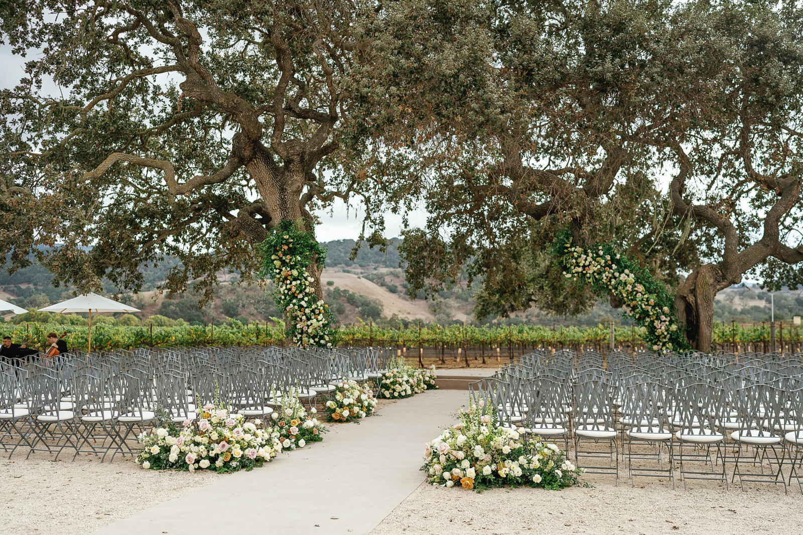 Outdoor wedding chairs set for ceremony under trees