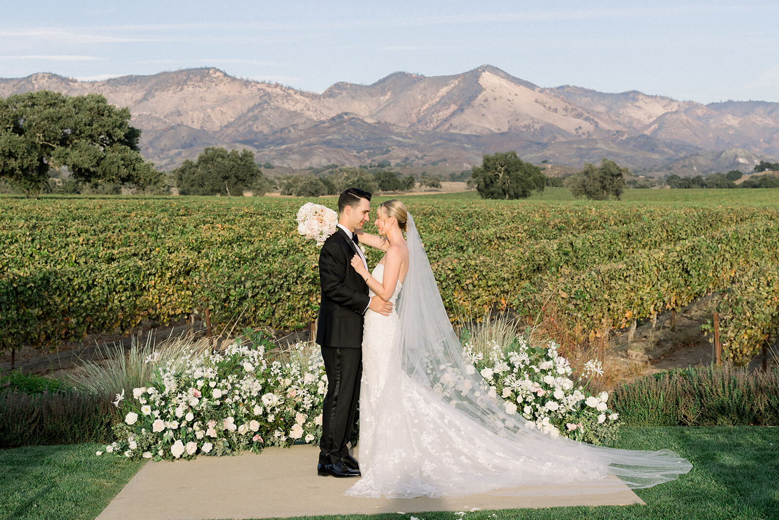 Weddings Couple getting married with mountains in the background